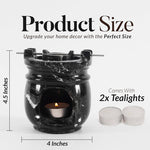 Black marble-patterned oil burner with two tealights on a white background